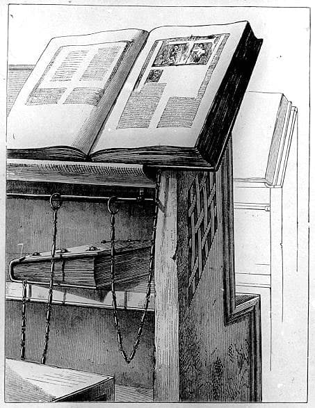 An engraving of a chained book on a lectern.